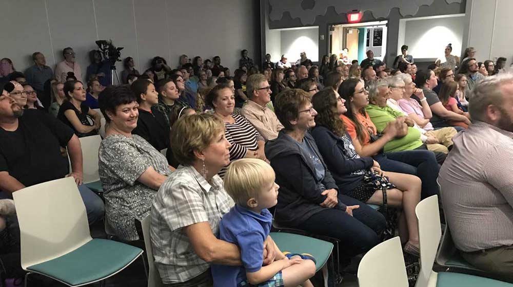 Audience of various ages enjoying a library concert by the Long Island Jazz Orchestra.